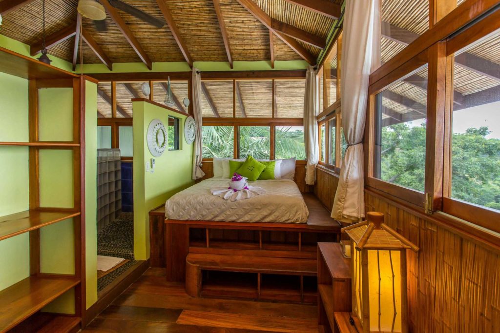 This bedroom offers comfort, exquisite woodwork, astonishing ocean views, and plenty of storage space.