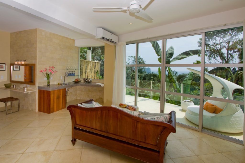 Enjoy the ocean view from the sitting area or out on the balcony of this luxury master bedroom.