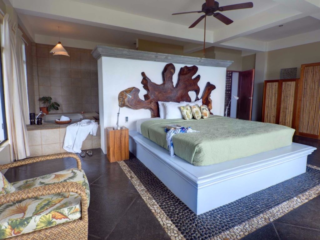This decorative master bedroom features a stunning king bed facing the Pacific ocean. 