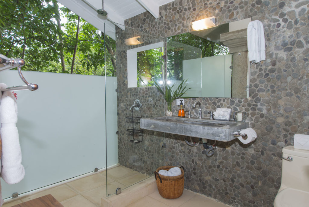 The luxurious ensuite bathroom in the separate guesthouse is open to the sights and sounds of the rainforest. 