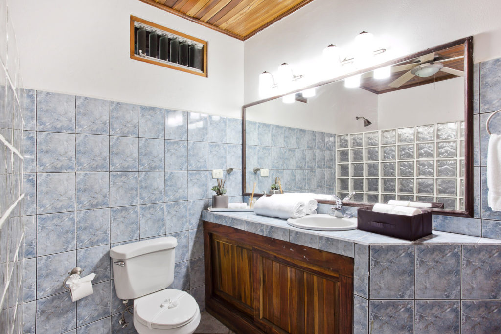 Deluxe bathroom with tile accents, a large shower, and all amenities included.