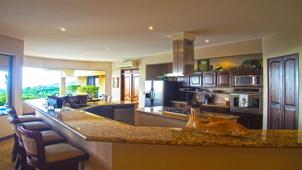 The huge bar in the kitchen with granite counter-tops 