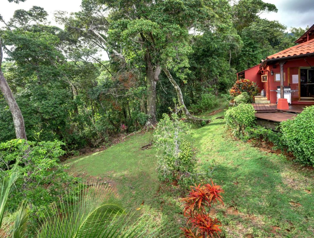 This private house sits on large oceanfront grounds surrounded by rainforest and gardens. 