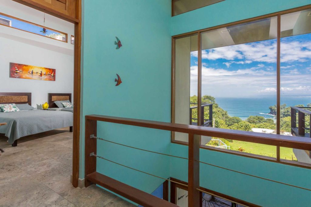 Huge windows with ocean views are found throughout, like here on the second-floor landing.