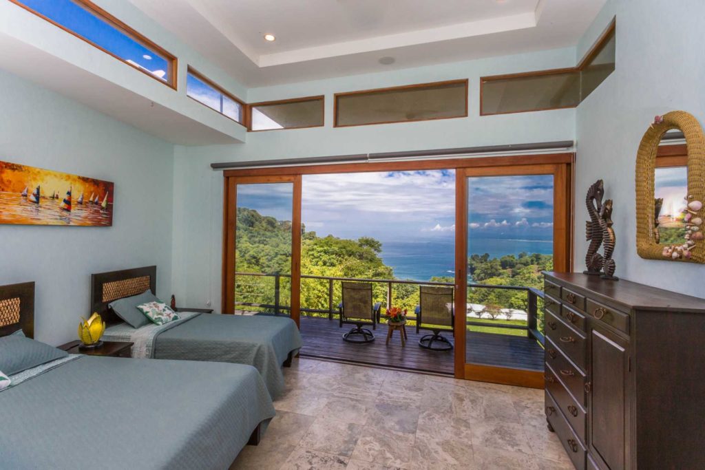 Walk out to the private balcony from this ocean-view bedroom. Gorgeous views are available all year round here.
