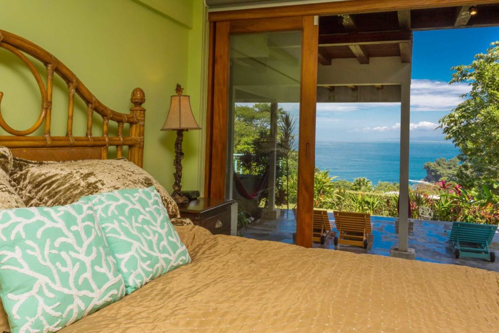 The downstairs ocean-view bedroom has a king and twin bed. Step out and enjoy your private covered balcony.