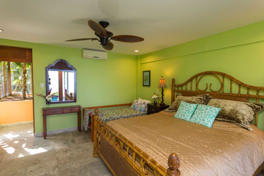 Sleep three in the downstairs bedroom with a king and twin bed. This four-bedroom villa can sleep up to twelve guests.