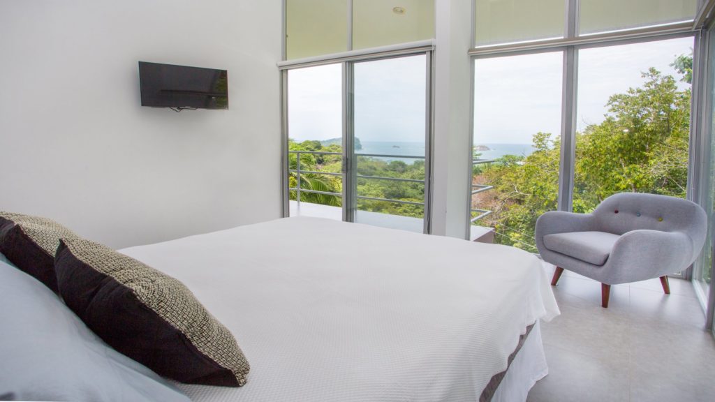 Enjoy the ocean views from the private balcony off this queen guest bedroom.