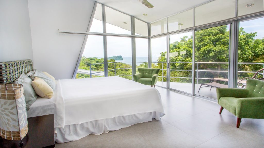 The awesome ocean view from the master bedroom can be enjoyed through the glass walls and on the private balcony.