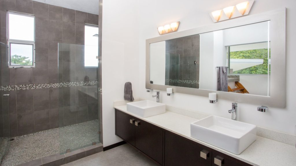 The luxurious master bathroom features his and hers sinks, a large walk in shower, and a separate Japanese soaking tub.