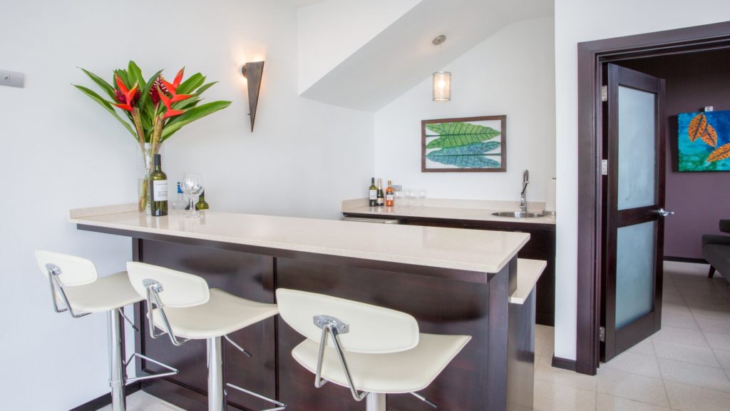 The convenient wet bar in the living room has seating and a mini refrigerator, a great feature for gatherings.