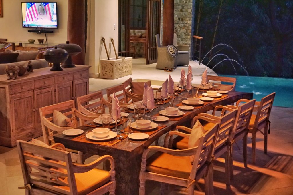 The huge dining table sits just next to the pool area and seats up to ten guests.
