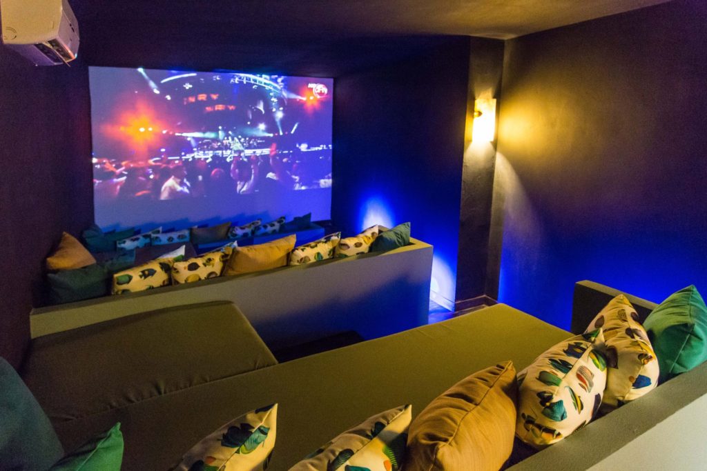 Relax and watch a movie in the private home theater. It has plenty of tiered seating and a huge screen.