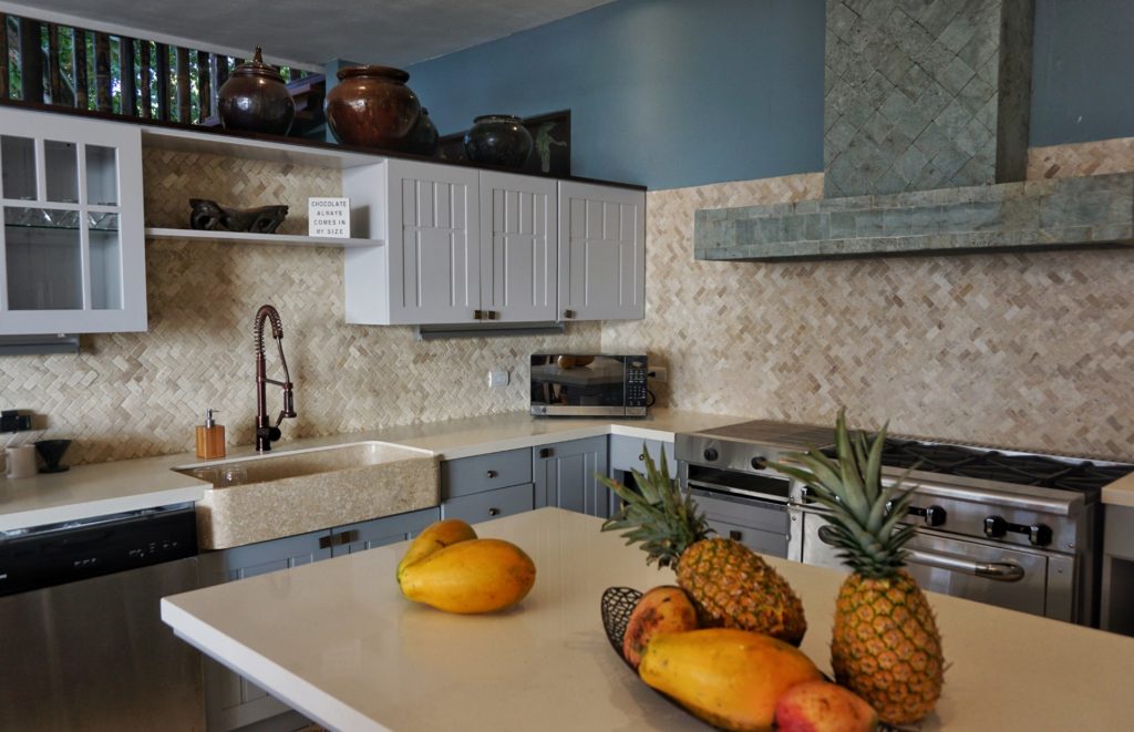 Native stone, granite, and hand-cut tile designs combine to make the kitchen unique beyond compare.