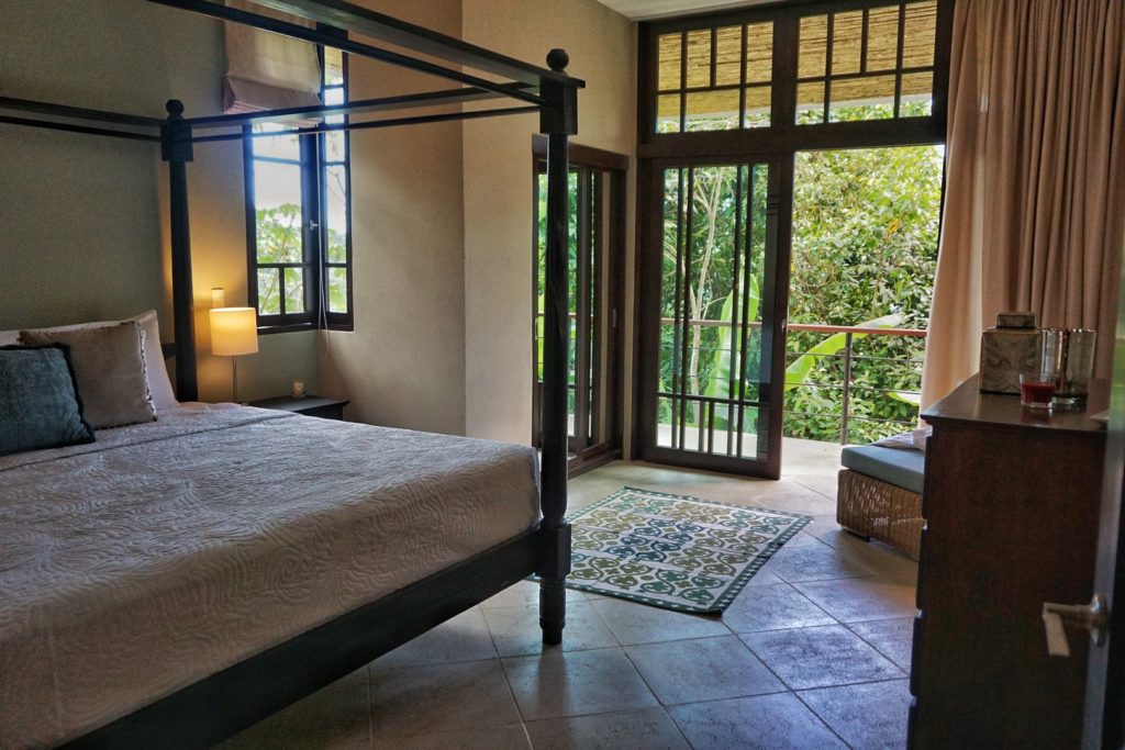 Enjoy the comfort of this beautiful king bed in your private jungle villa.