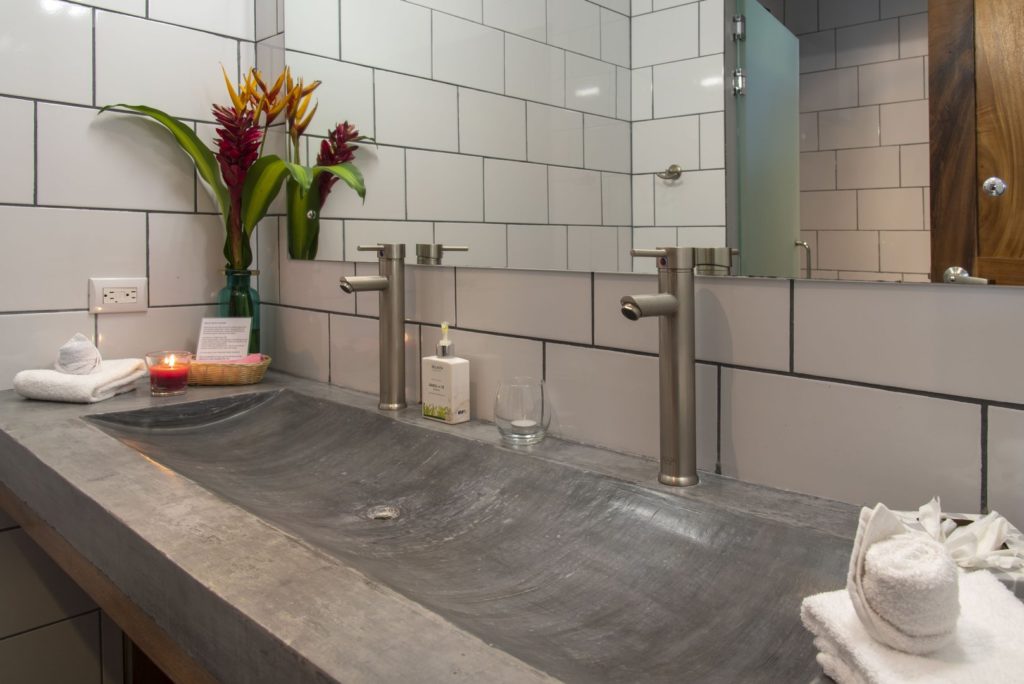 This bathroom features a large mirror and double sinks.