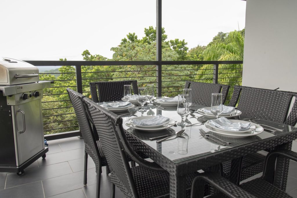 The terrace outside the kitchen features a modern grill and a stunning view.