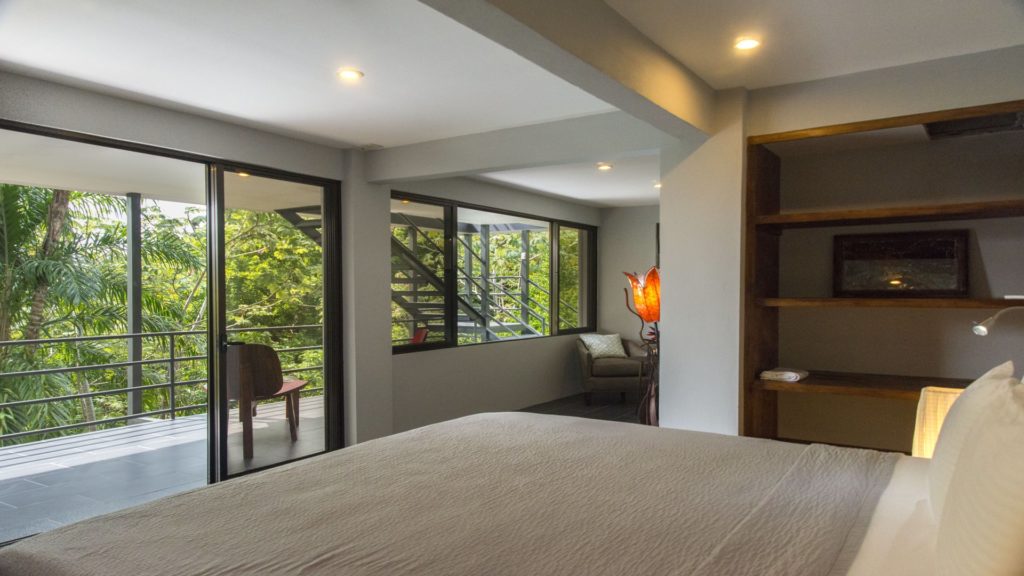The master bedroom has direct access to the balcony area.