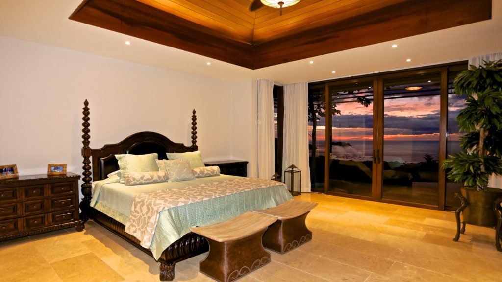 The furnishings are unlike anything you will see at other villas. This immaculately-designed king bedroom has patio access and an ocean view. 