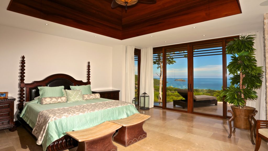 Step out to your own balcony area from this luxurious king bedroom. Large glass doors offer a fantastic ocean view. 