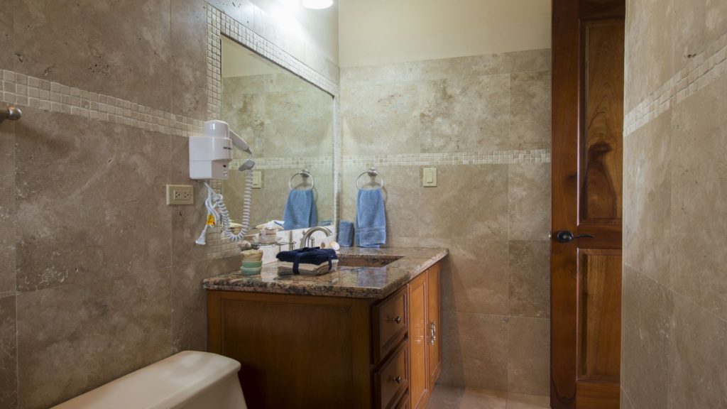 One of the 2 en-suite guest bathrooms with granite counter-tops and all amenities.