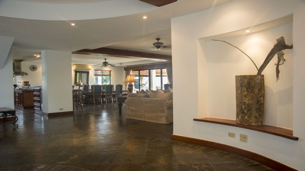 The large communal area has exquisite tile flooring, beamed ceilings, and is immaculately furnished.
