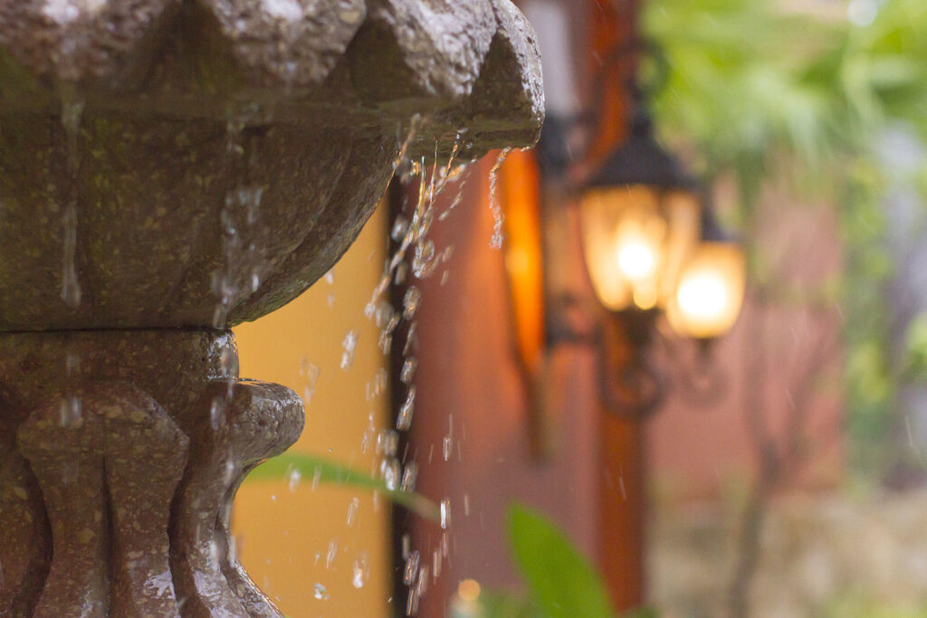 The impressive entrance is lined with a lush garden complete with working fountains.