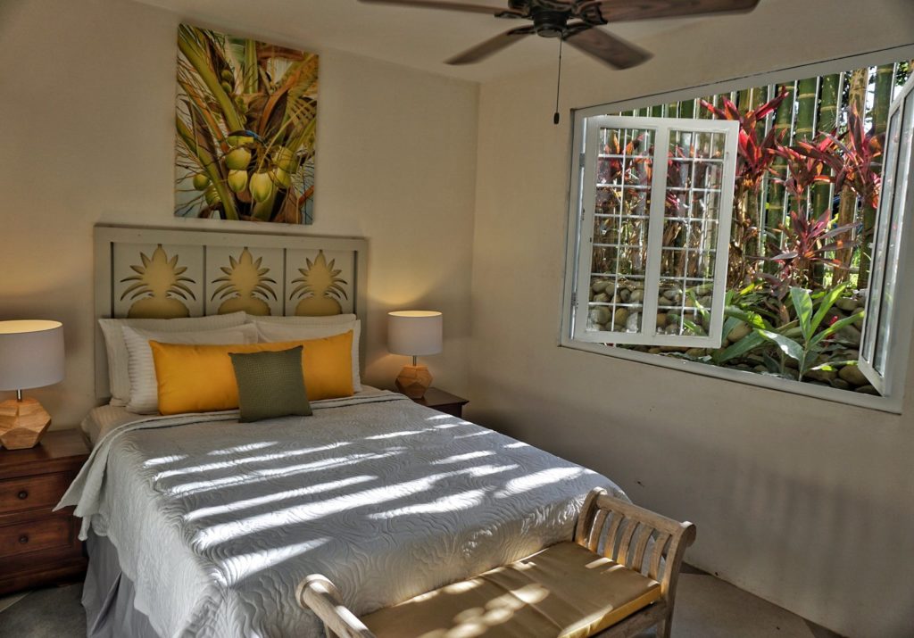 Beautiful guest bedroom in the main house with full size bed and air conditioning.