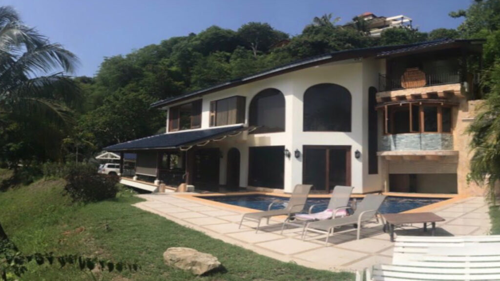 View of the villa with pool and lounge area