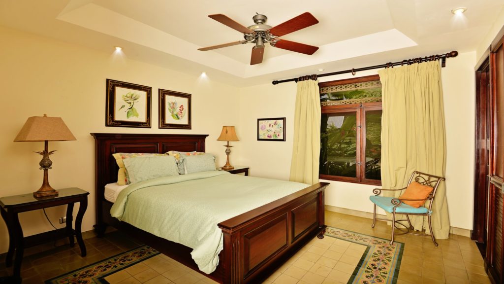 Gracefully appointed, this bedroom presents a magnificent vista of luxuriant verdure.