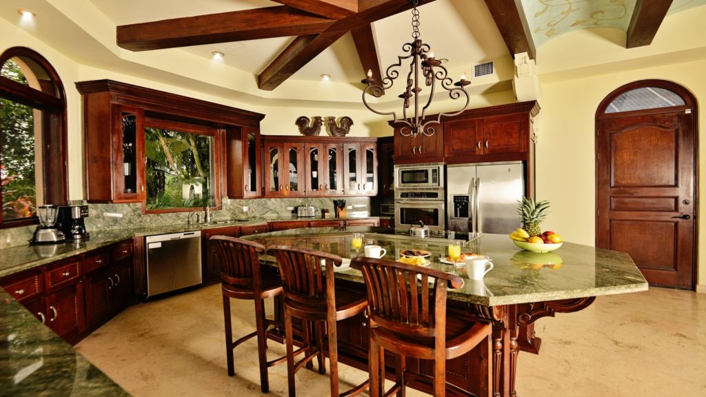 Gather your loved ones in this inviting, well-appointed kitchen, complete with top-notch amenities. The lush tropical garden provides a stunning backdrop for culinary delights and cherished moments.