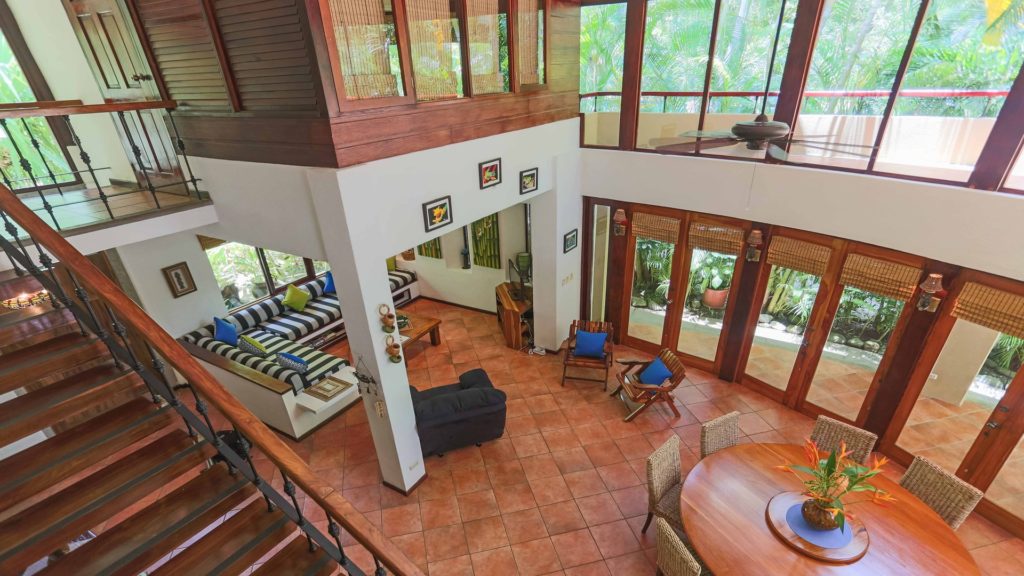 The terracotta-tiled living area is full of natural light and accented with native hardwoods for a tropical vibe. 