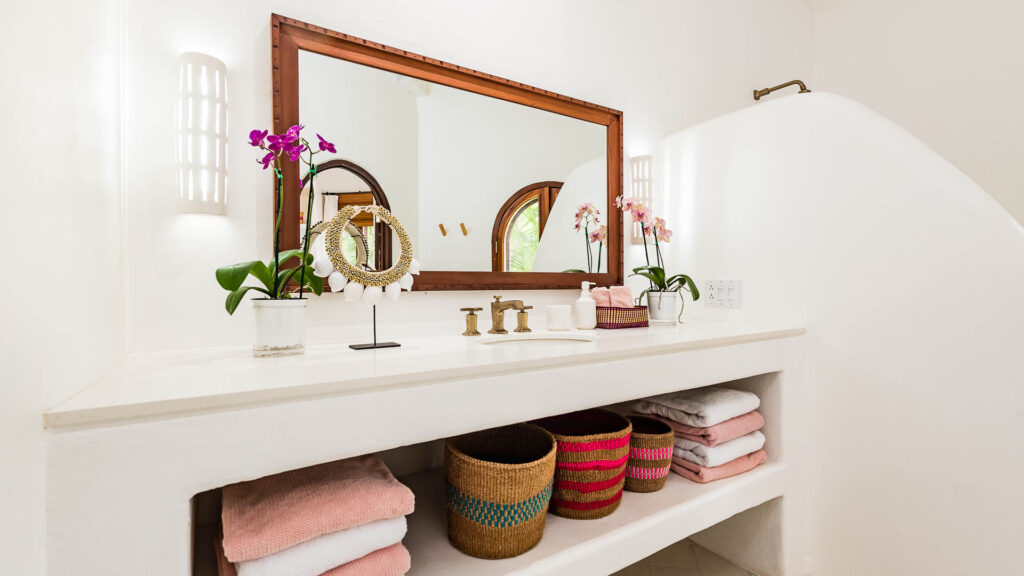 A clean bathroom with extra large mirror.