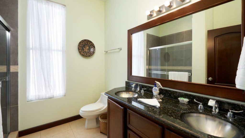 This bathroom has his and hers sinks with large mirror.