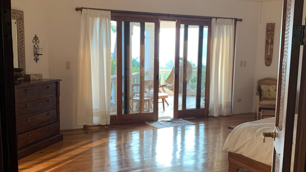 This bedroom has custom sliding doors right out to the porch area so you can let in the fresh breeze.