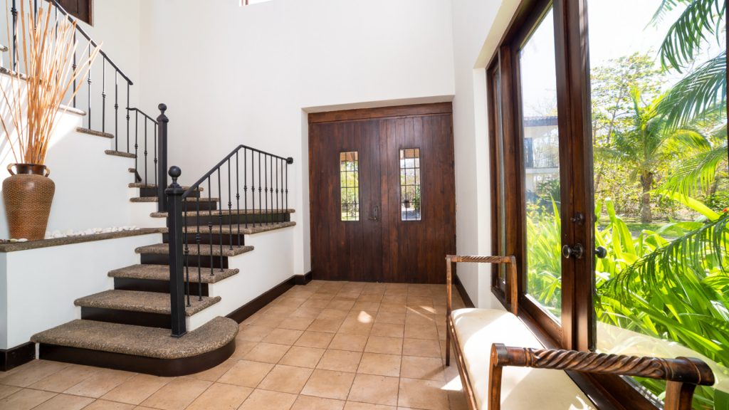 A large foyer with stairs off to the side and seating.