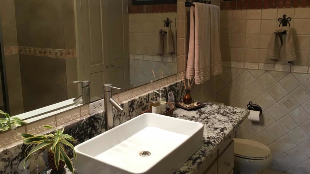 Enjoy using this large bathroom with a full size mirror and deep sink for washing.