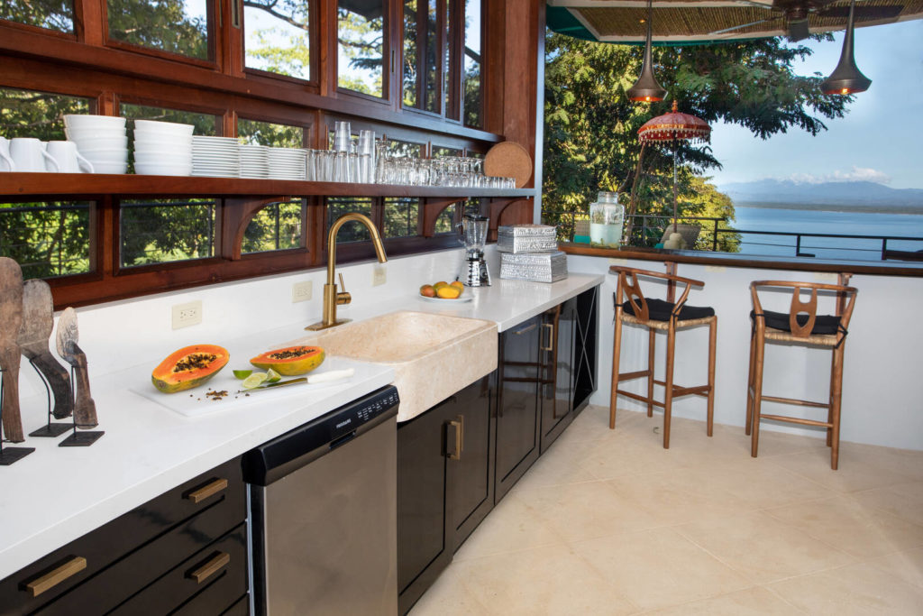 The luxury modern kitchen has a spacious layout and an amazing view.