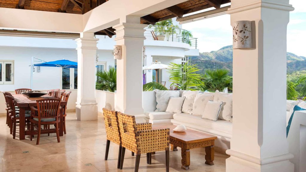 A covered patio with beautiful seating arrangements. 