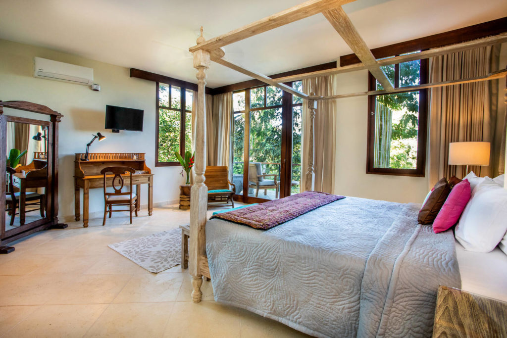 This light spacious master bedroom has stunning views and a hand-carved poster bed.