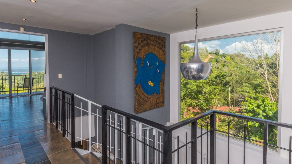 The villa is filled with unique artwork like this large painting on the staircase.