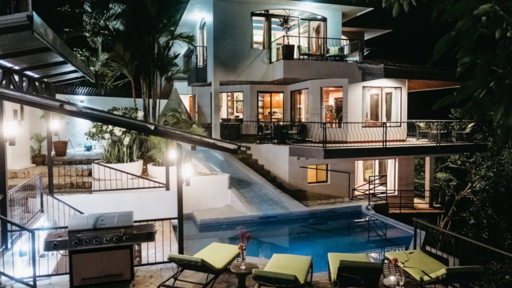 A sparkling evening view of the villa and pool area of this newly remodeled property.