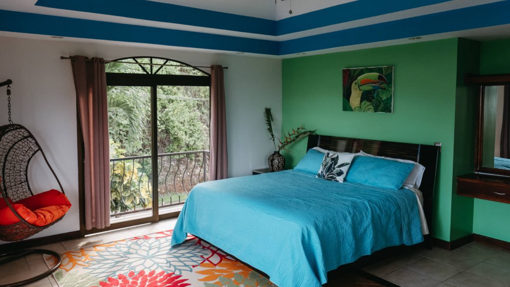 The large master bedroom is bright and spacious with two private balconies.