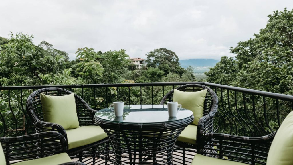 There is a table and chairs for four on the living room balcony with a remarkable view.