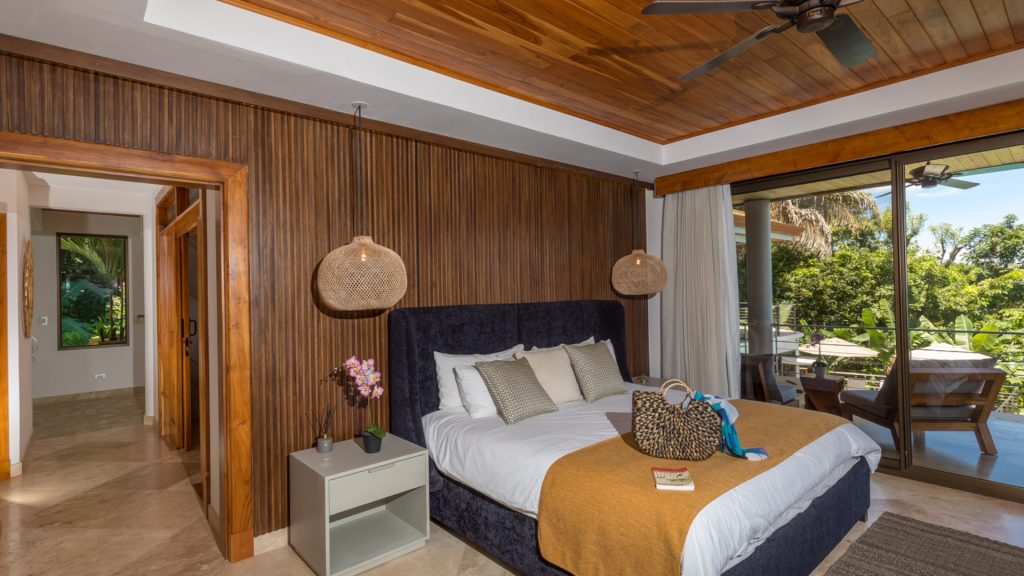The warm natural vibe in this bedroom comes from wooden panelling in the walls and ceiling.