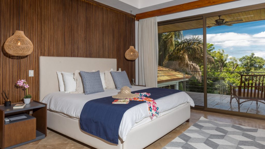Wake up in paradise every morning in this comfortable wooden-panelled bedroom to a breathtaking view.