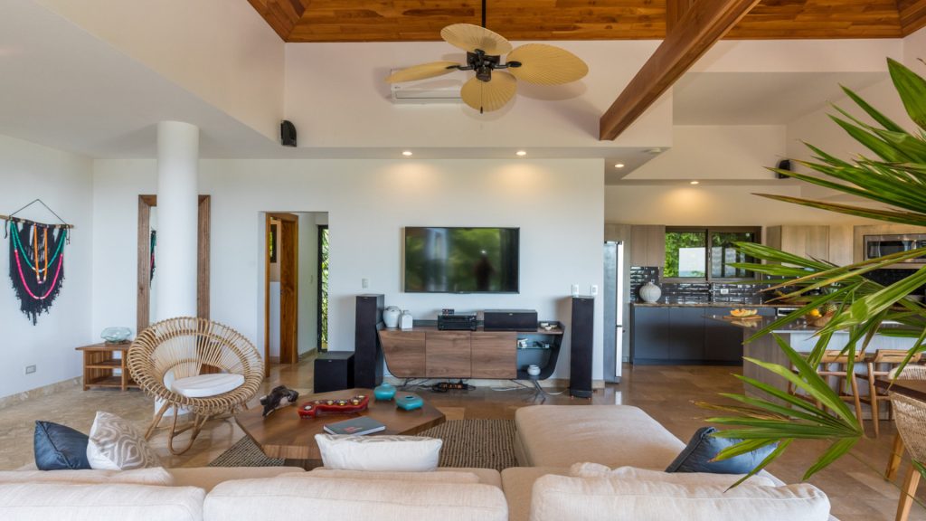 The large-screen TV provides family entertainment and relaxation in the lounge area with vaulted ceilings.