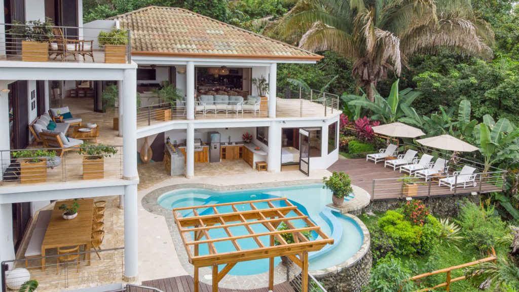 In this view of the home and pool area you can see the lush jungle setting and all the incredible spaces to relax.