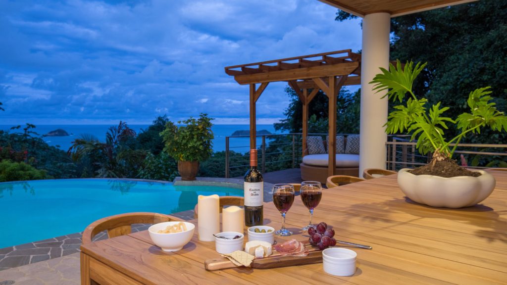 The large pool area has lots of space for dining. Enjoy a glass of wine while gazing at the outstanding ocean view.