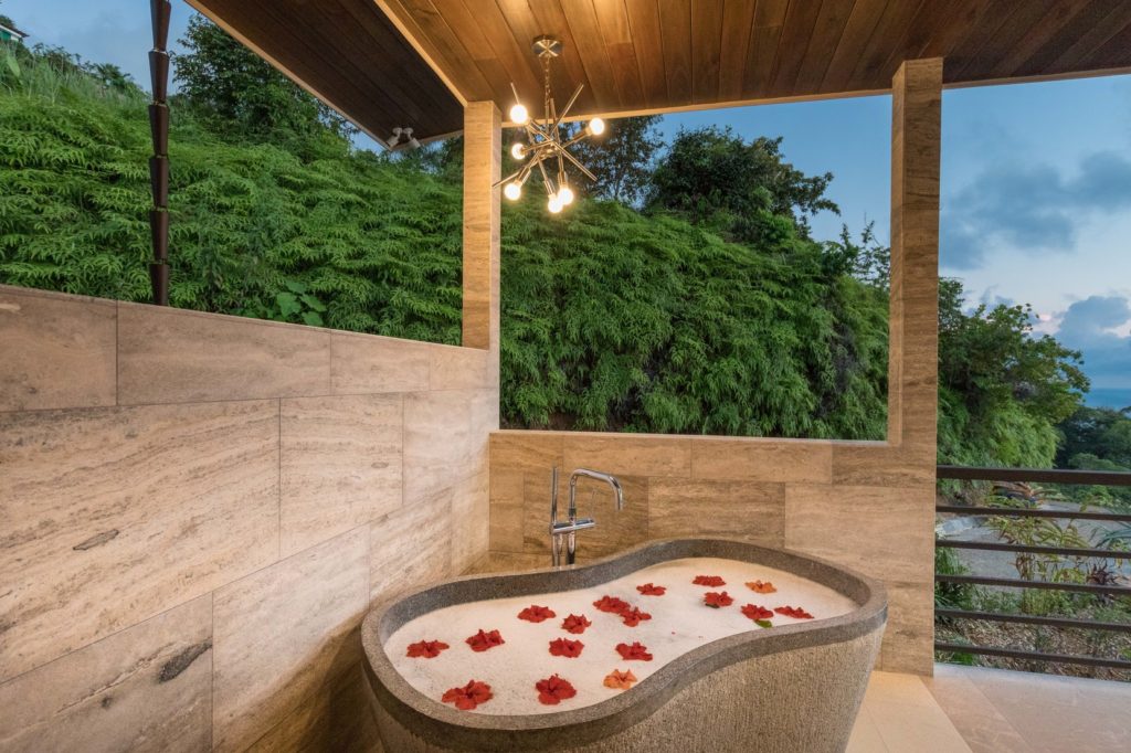 Listen to the sounds of nature while soaking in the beautiful stone tub imported from Bali.